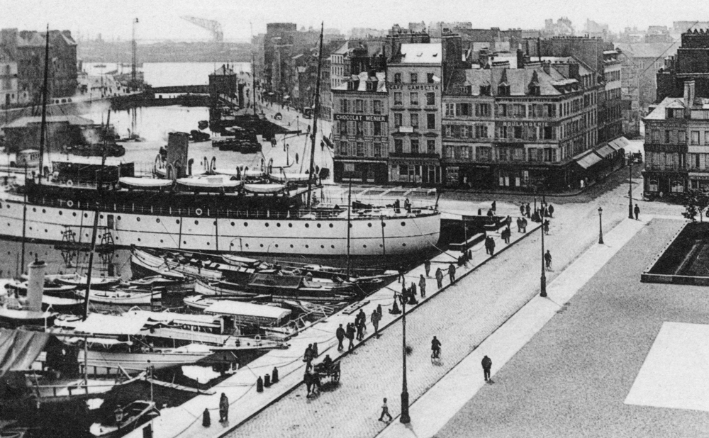 Vue du Havre dans les années 1900. À droite, la place Gambetta. À gauche, le bassin du Commerce. À l’arrière-plan à gauche, la place de l’Arsenal, le quai Videcocq et le bassin du Roy. Entre les deux, le quai de Lamblardie. Au fond, le port. Carte postale. Coll. Mémoire Vive.